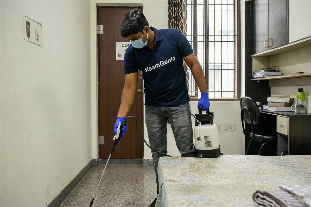KaamGenie pest control technician treating a student rental flat in Jamia Nagar, Okhla, South-East Delhi