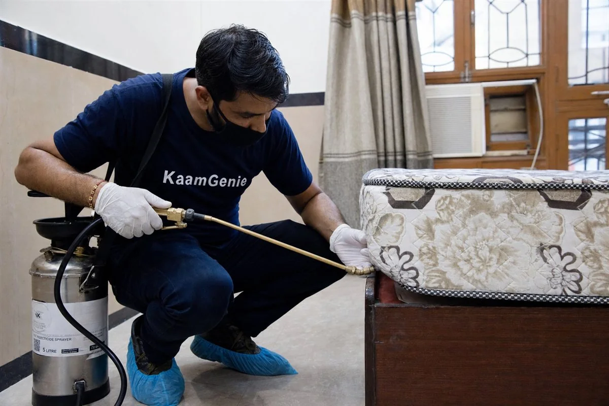 KaamGenie pest control technician treating a Karkardooma property in East Delhi