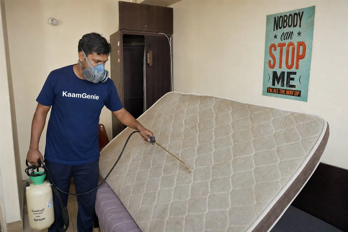 KaamGenie pest control technician treating a Khirki Extension property in South Delhi
