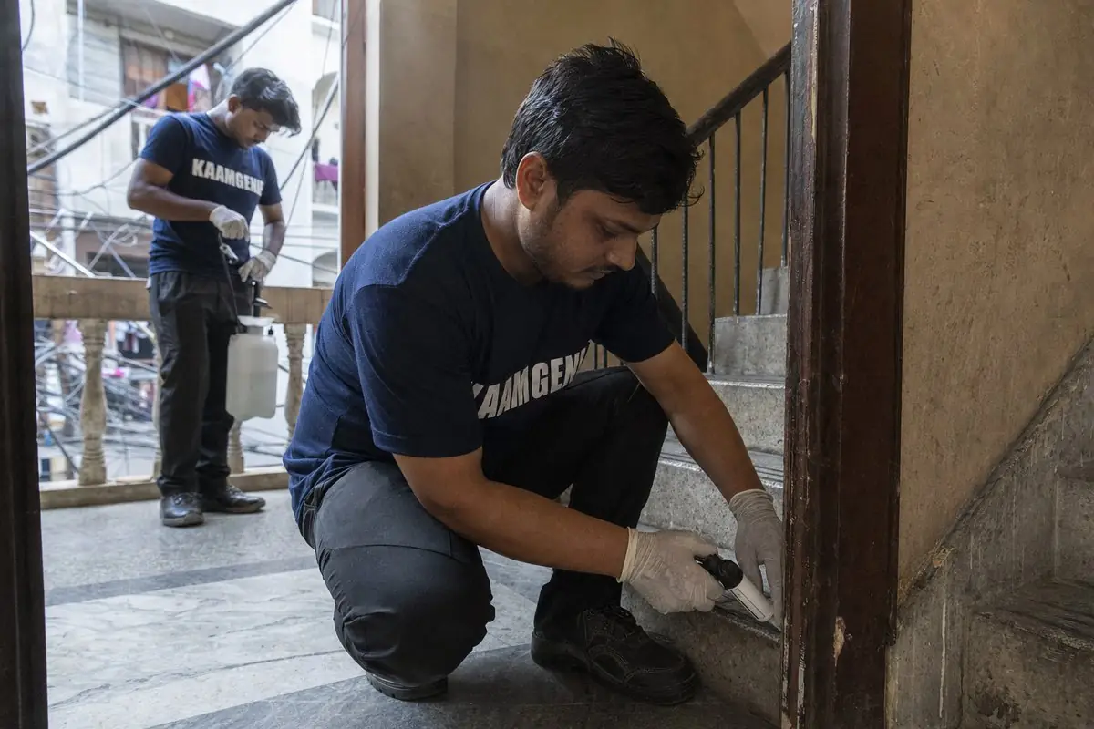 KaamGenie pest control technician treating a Khirki Village property in South Delhi