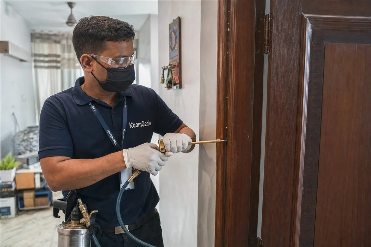 KaamGenie pest control technician treating a Maujpur property in East Delhi