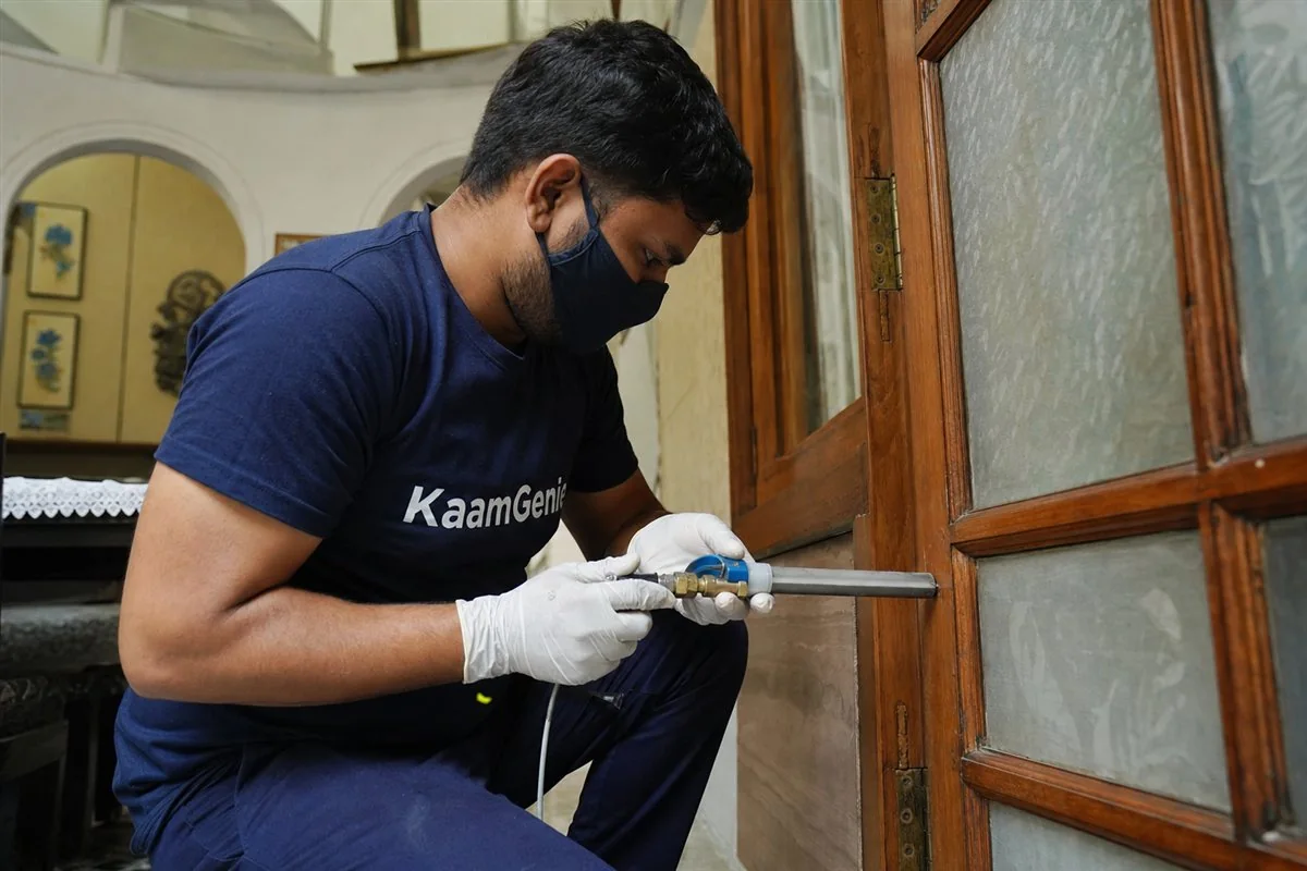 KaamGenie pest control technician treating a Model Town property in North-West Delhi