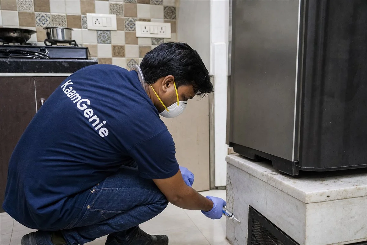 KaamGenie pest control technician treating a Nand Nagri A Block property in East Delhi
