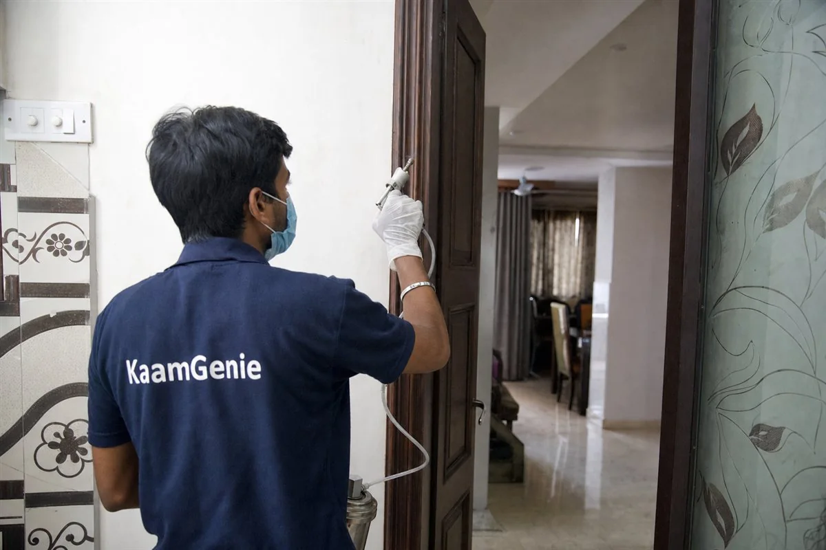 KaamGenie pest control technician treating a Nand Nagri C Block property in East Delhi