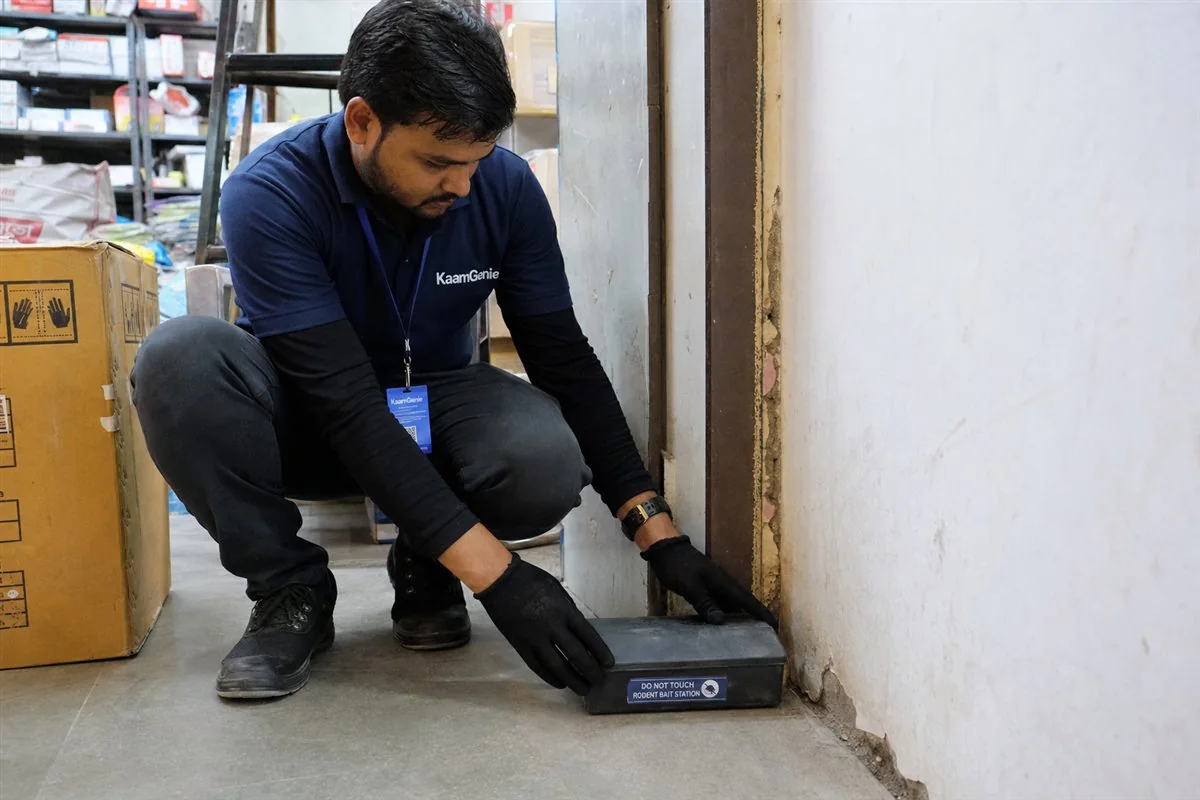 KaamGenie pest control technician treating a New Ashok Nagar property in East Delhi
