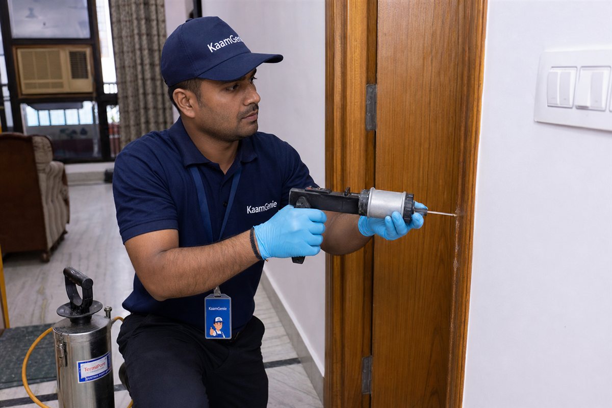 KaamGenie pest control technician treating a Rohini Sector 23 property in North-West Delhi