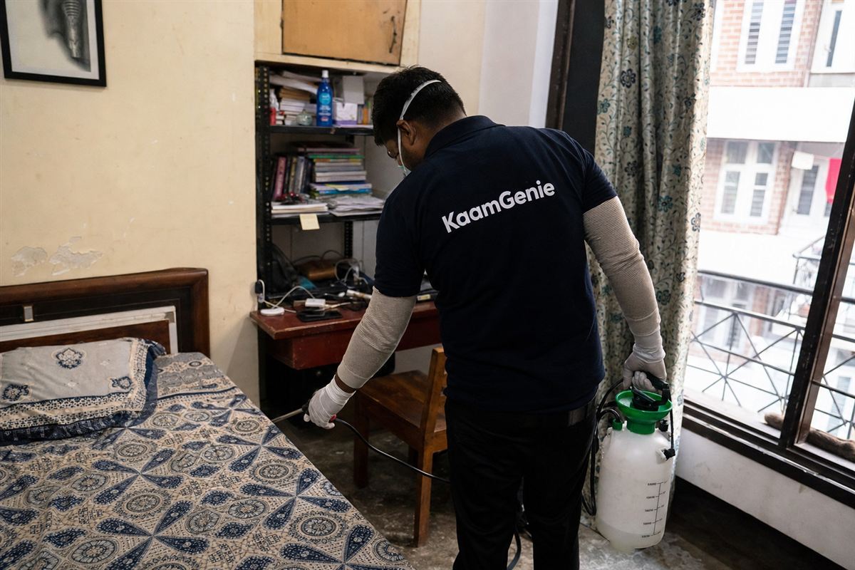 KaamGenie pest control technician treating a Roop Nagar property in North Delhi