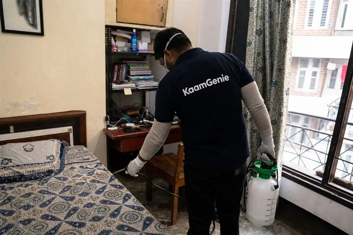 KaamGenie pest control technician treating a Roop Nagar property in North Delhi