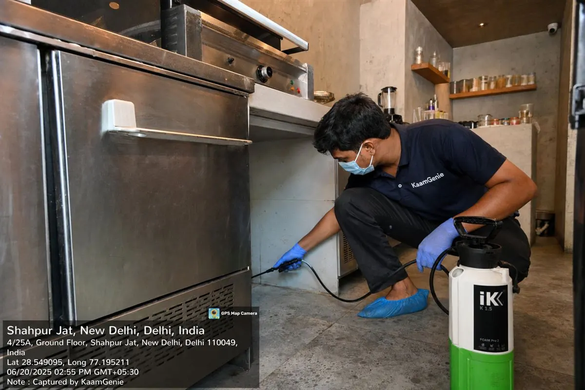 KaamGenie pest control technician treating a boutique-cafe in Shahpur Jat, near Hauz Khas, South Delhi