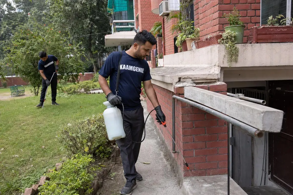 KaamGenie pest control technician treating a Tara Apartments property in South Delhi