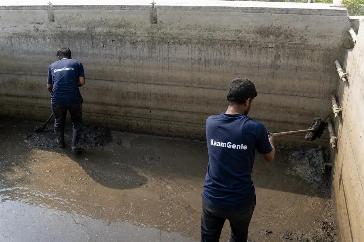KaamGenie crew cleaning a Noida society underground reservoir, with cleaning certificates and before-after photos being recorded