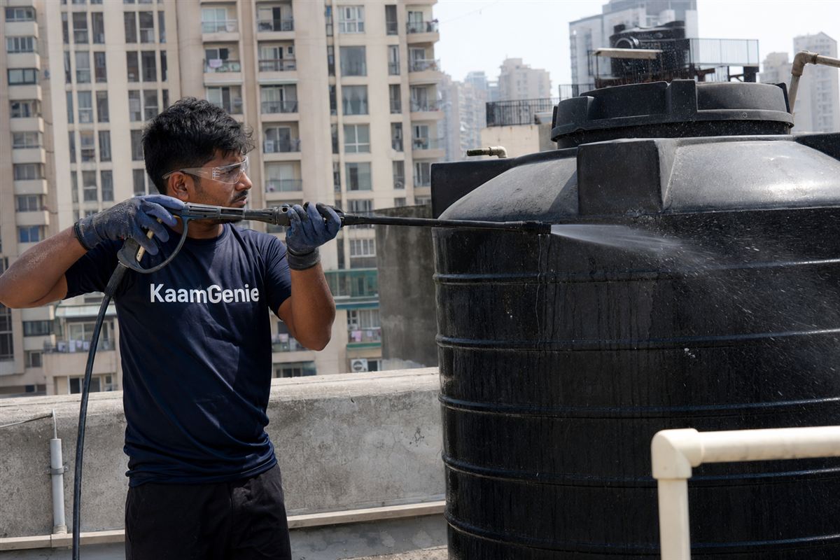 KaamGenie crew dispatched same-day, carrying cleaning equipment to a Noida apartment rooftop tank
