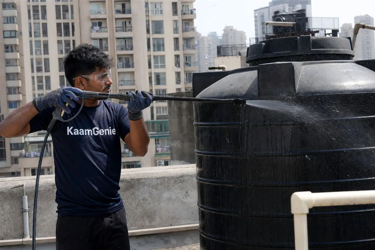 KaamGenie crew dispatched same-day, carrying cleaning equipment to a Noida apartment rooftop tank