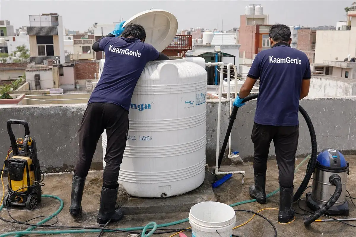 KaamGenie crew cleaning a water tank in Satbari, Delhi