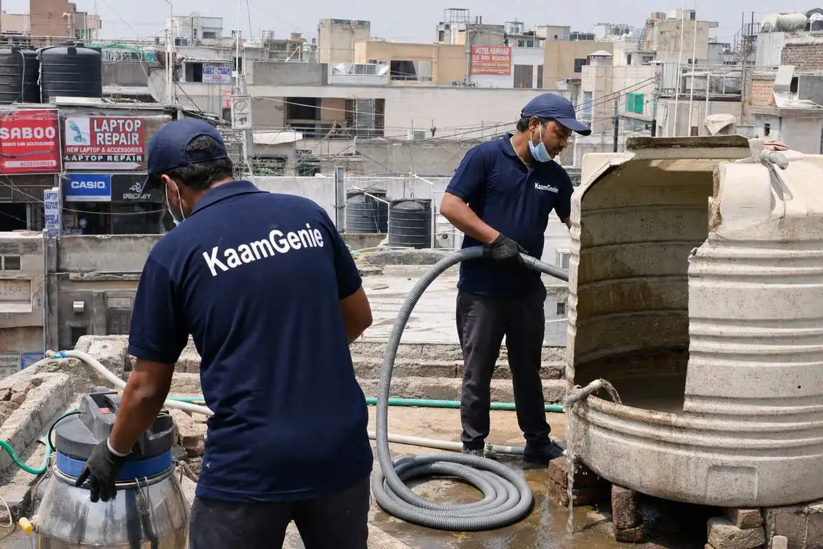 KaamGenie crew cleaning a commercial water tank in Lajpat Nagar, Delhi