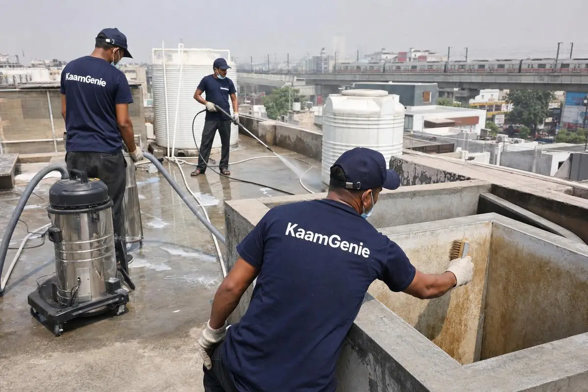 KaamGenie crew cleaning a commercial water tank in Malviya Nagar, Delhi