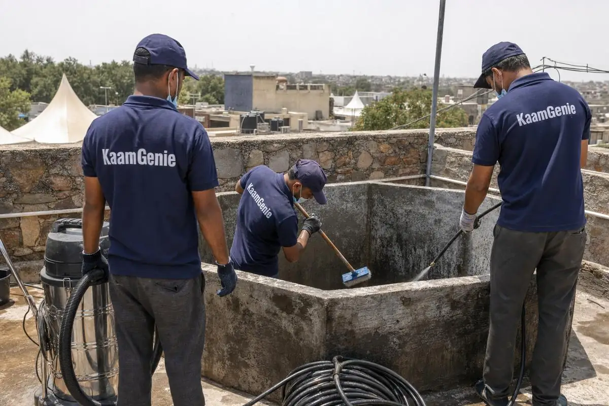 KaamGenie crew cleaning a commercial water tank in Mehrauli, Delhi