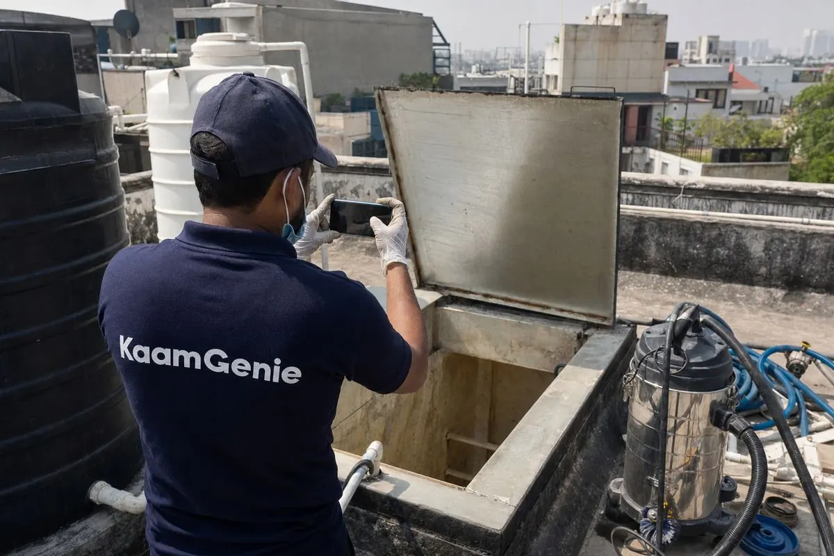 KaamGenie crew cleaning a commercial water tank in New Friends Colony, Delhi