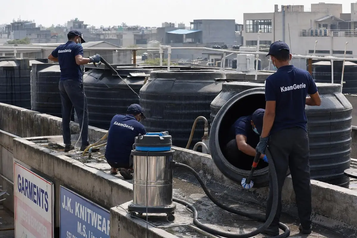 KaamGenie crew cleaning a commercial water tank in Okhla Phase 3, Delhi