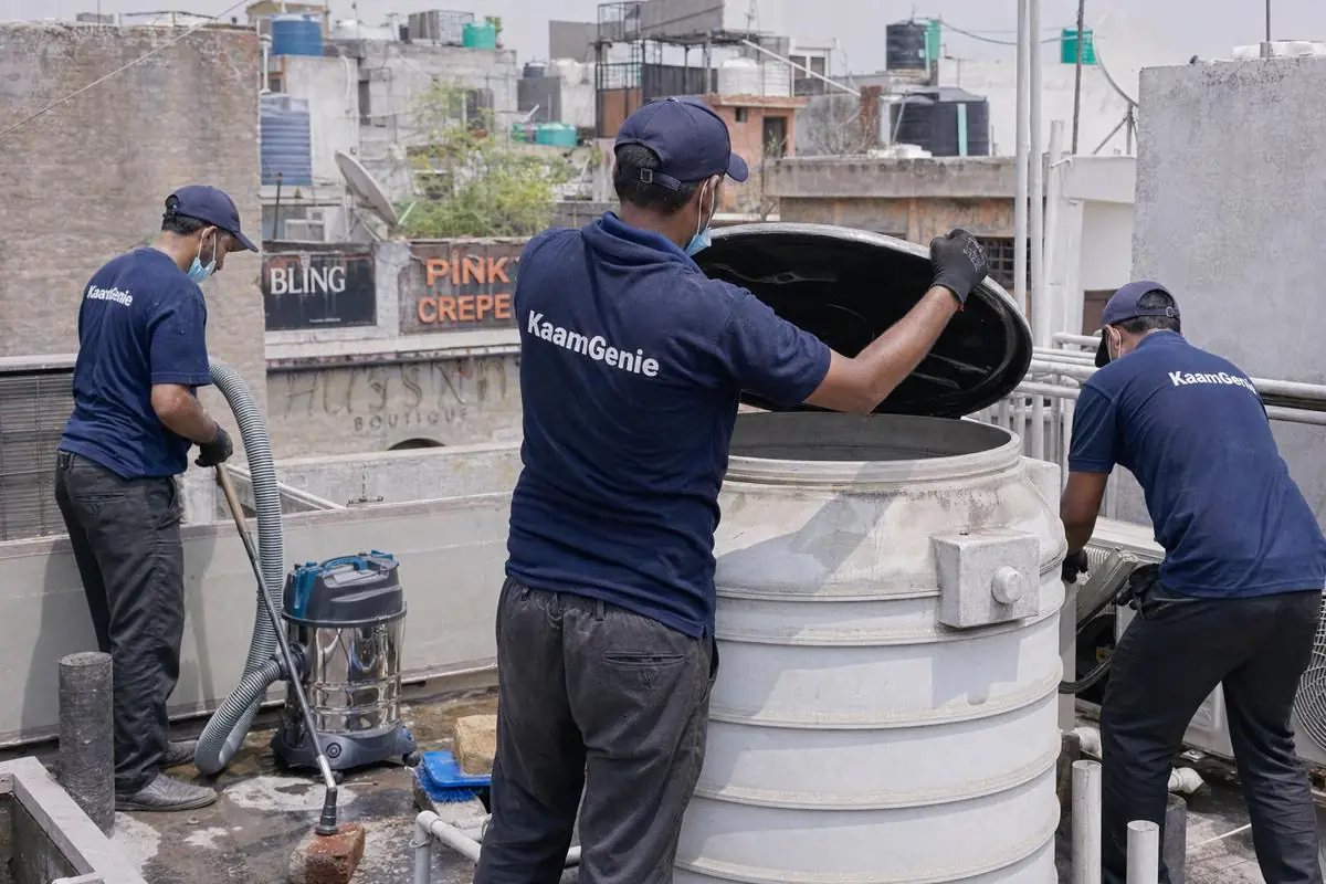 KaamGenie crew cleaning a commercial water tank in Shahpur Jat, Delhi
