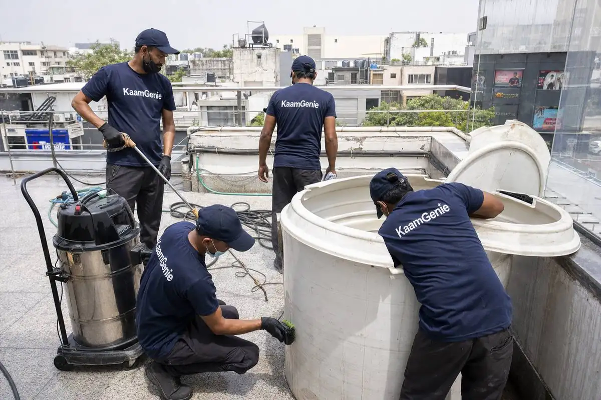 KaamGenie crew cleaning a commercial water tank in South Extension, Delhi