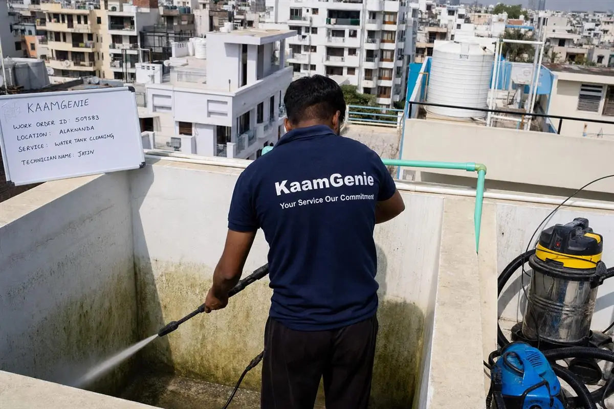 KaamGenie crew cleaning a overhead (rooftop) tank in Alaknanda, Delhi