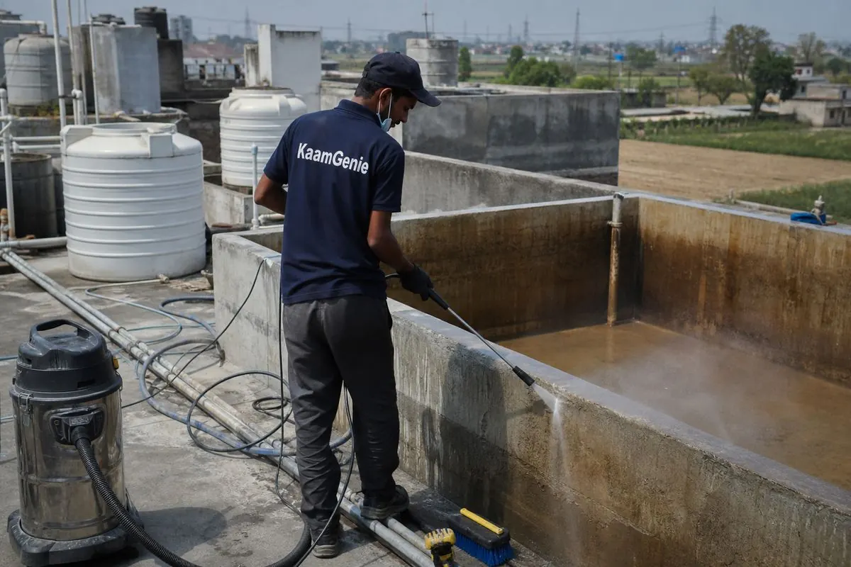KaamGenie crew cleaning a overhead (rooftop) tank in Alipur, Delhi