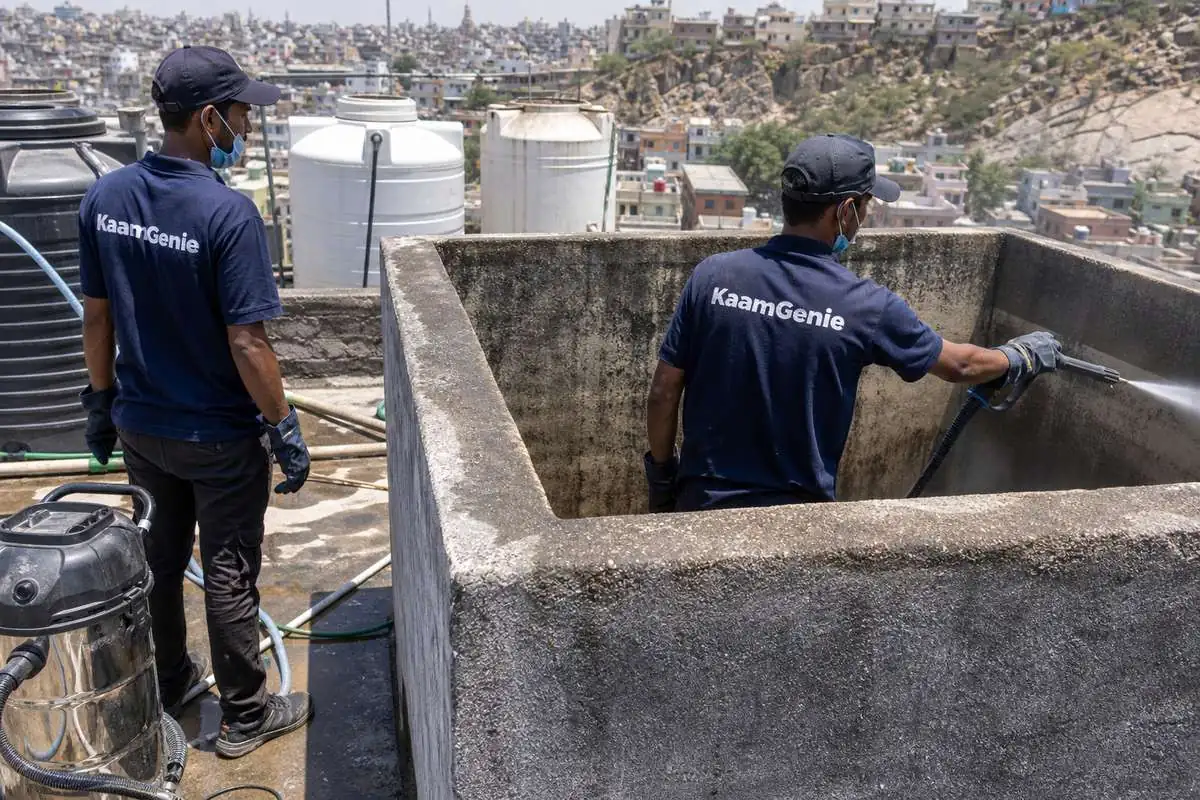 KaamGenie crew cleaning a overhead (rooftop) tank in Anand Parbat, Delhi