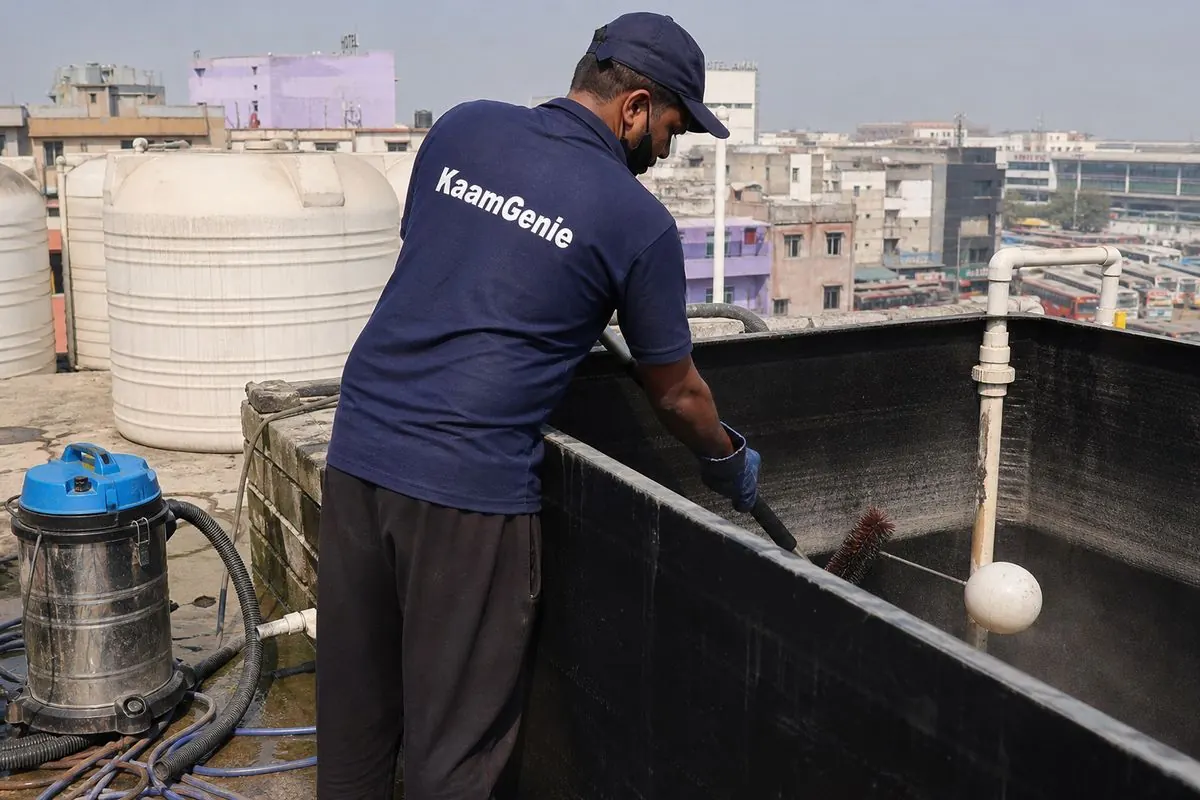 KaamGenie crew cleaning a overhead (rooftop) tank in Anand Vihar, Delhi