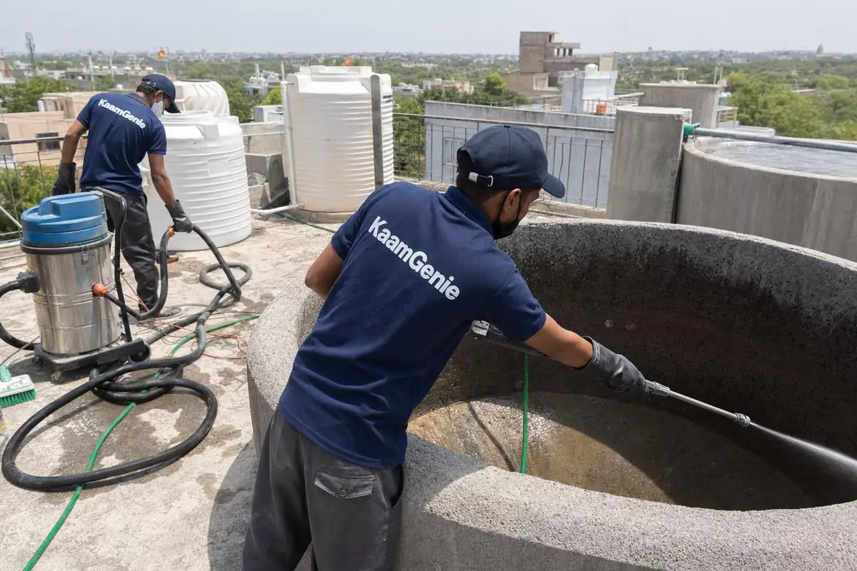 KaamGenie crew cleaning a overhead (rooftop) tank in Asola, Delhi