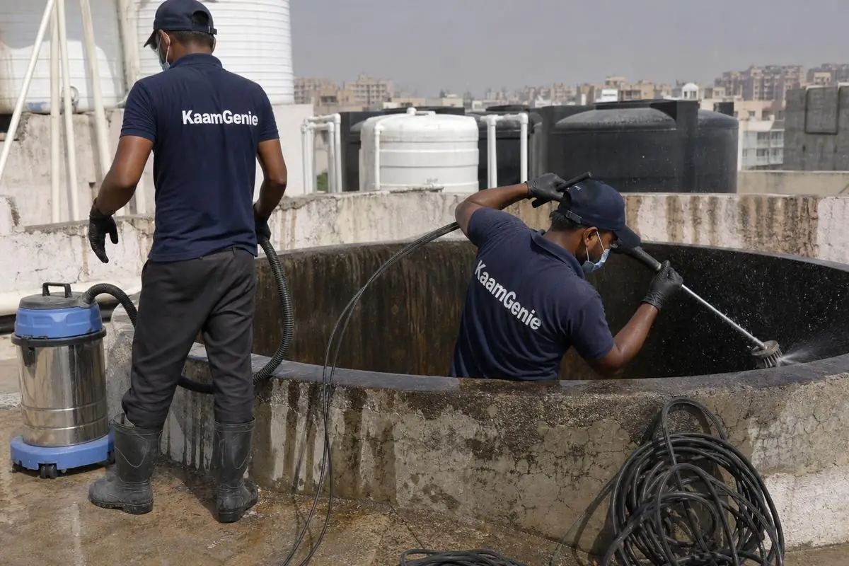 KaamGenie crew cleaning a overhead (rooftop) tank in Avantika, Delhi