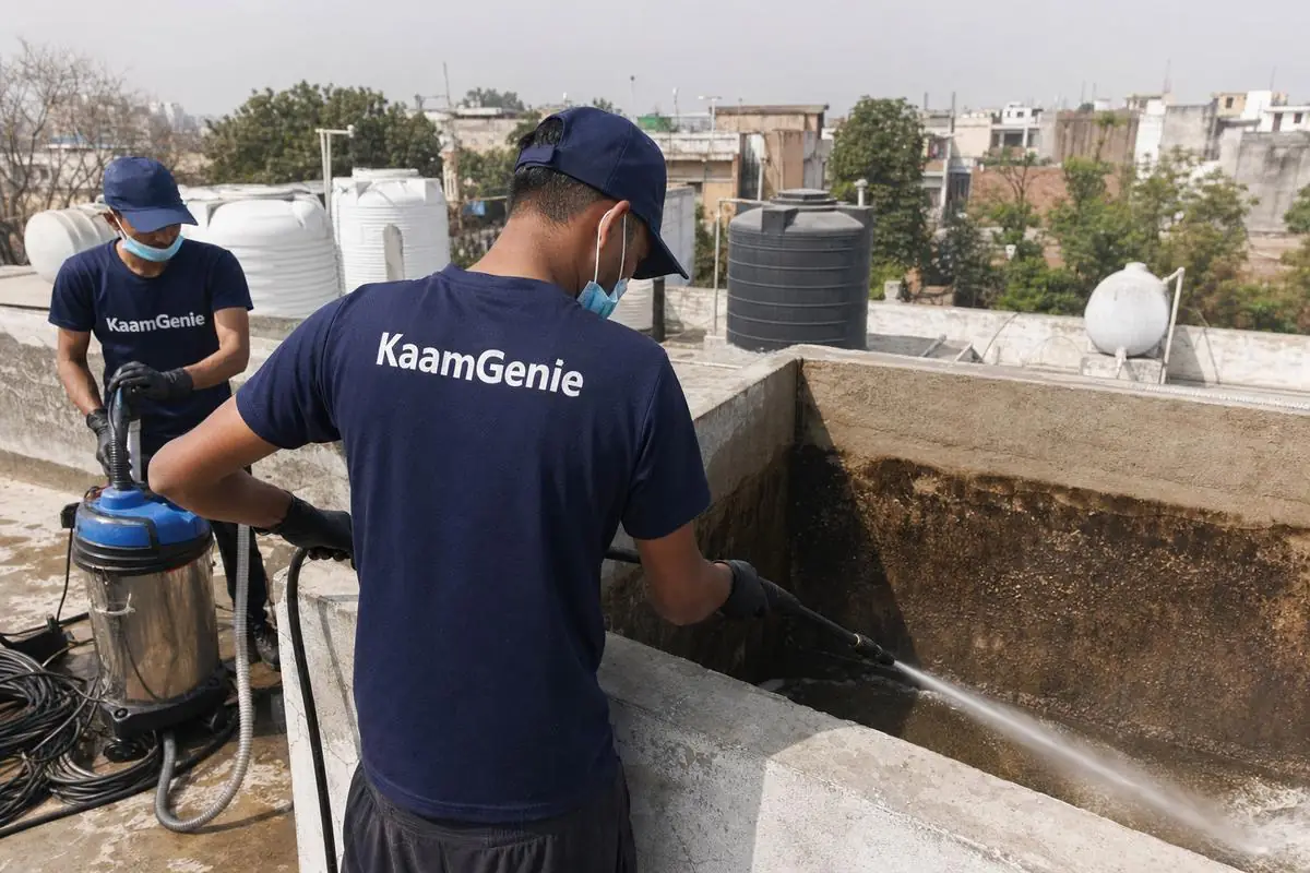 KaamGenie crew cleaning a overhead (rooftop) tank in Aya Nagar, Delhi