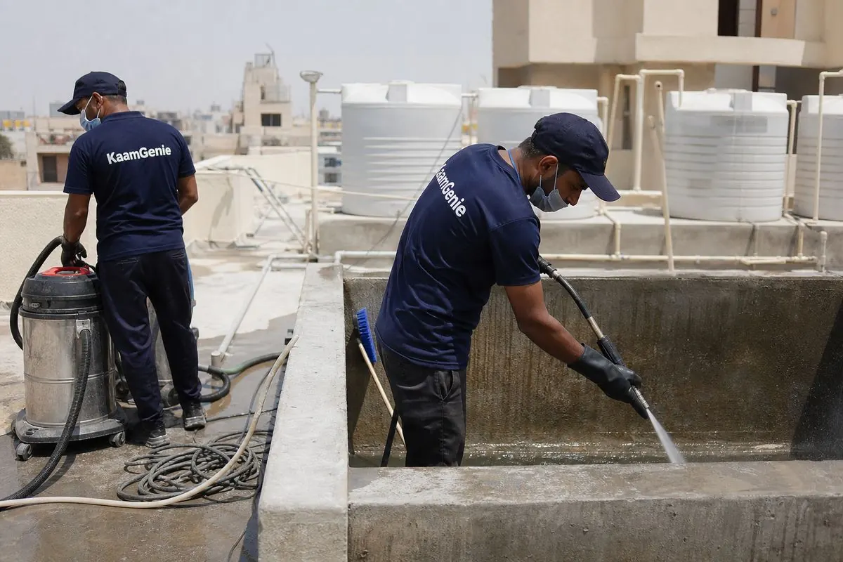 KaamGenie crew cleaning a overhead (rooftop) tank in Bakkarwala, Delhi