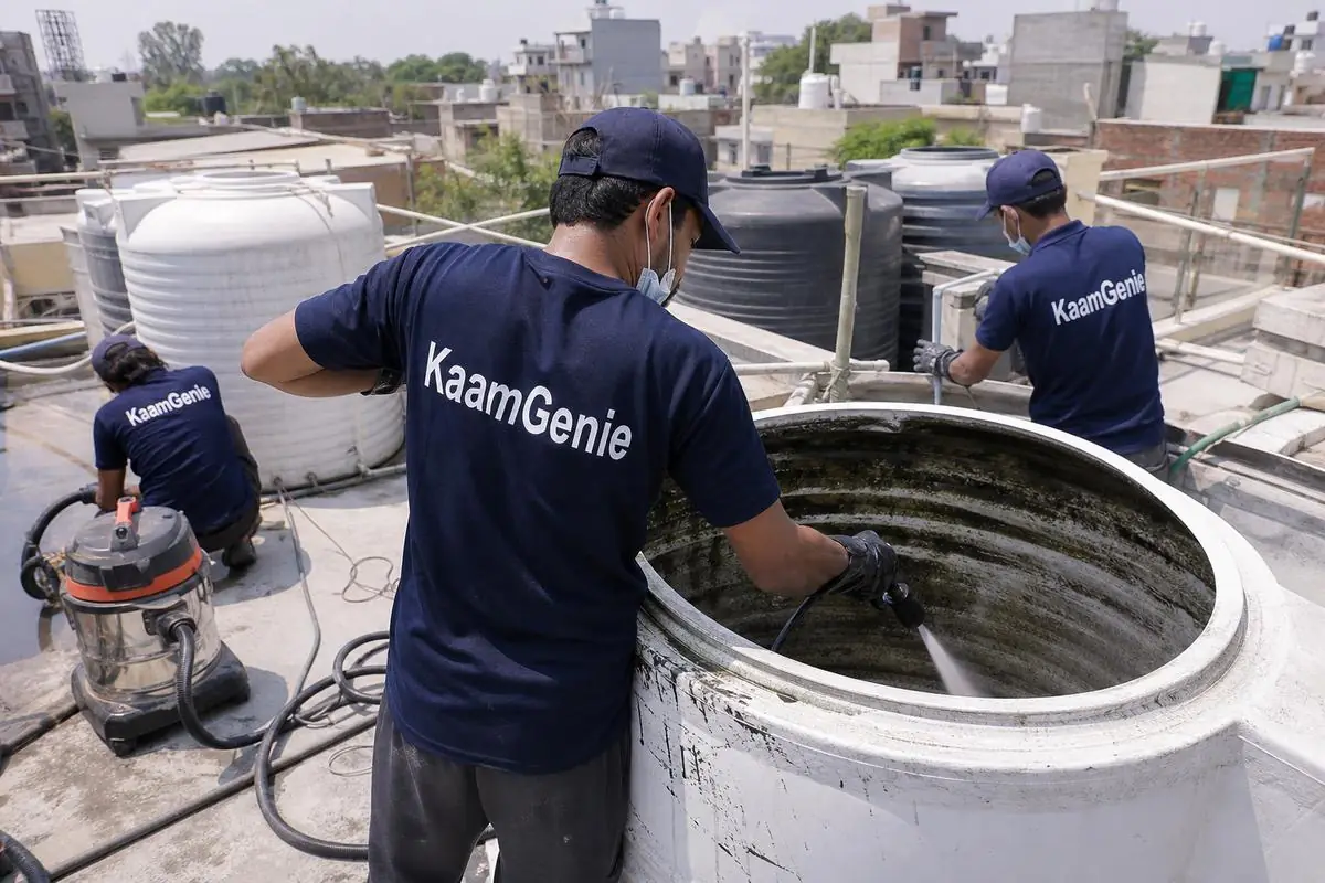 KaamGenie crew cleaning a overhead (rooftop) tank in Bali Nagar, Delhi
