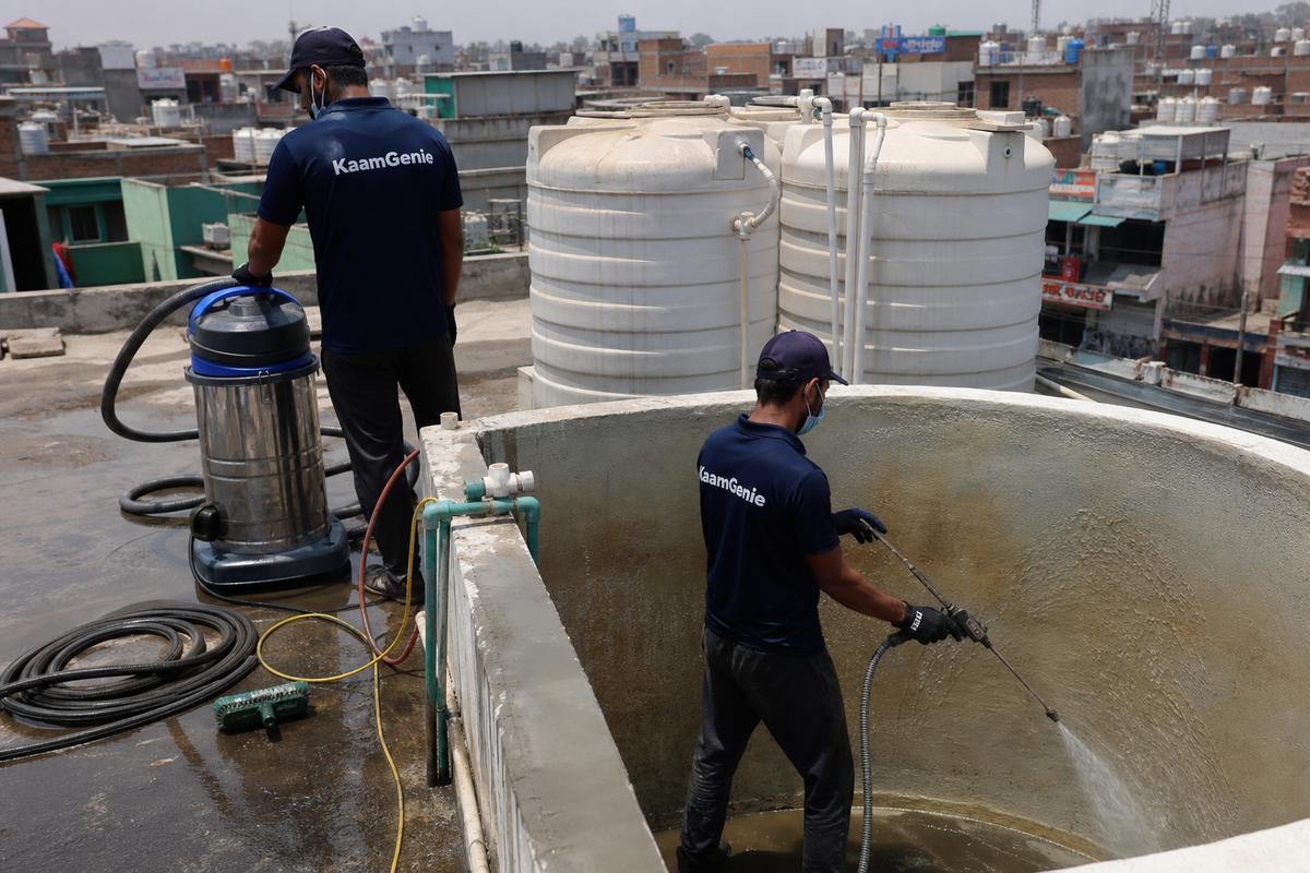 KaamGenie crew cleaning a overhead (rooftop) tank in Bhajanpura, Delhi