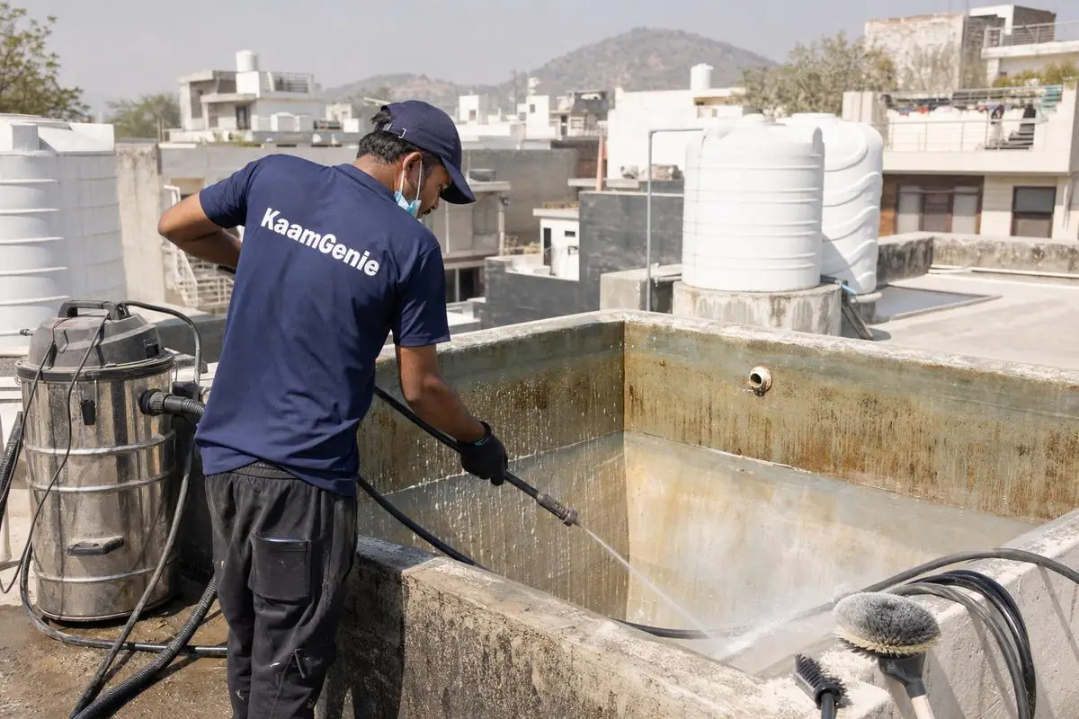 KaamGenie crew cleaning a overhead (rooftop) tank in Bhati, Delhi