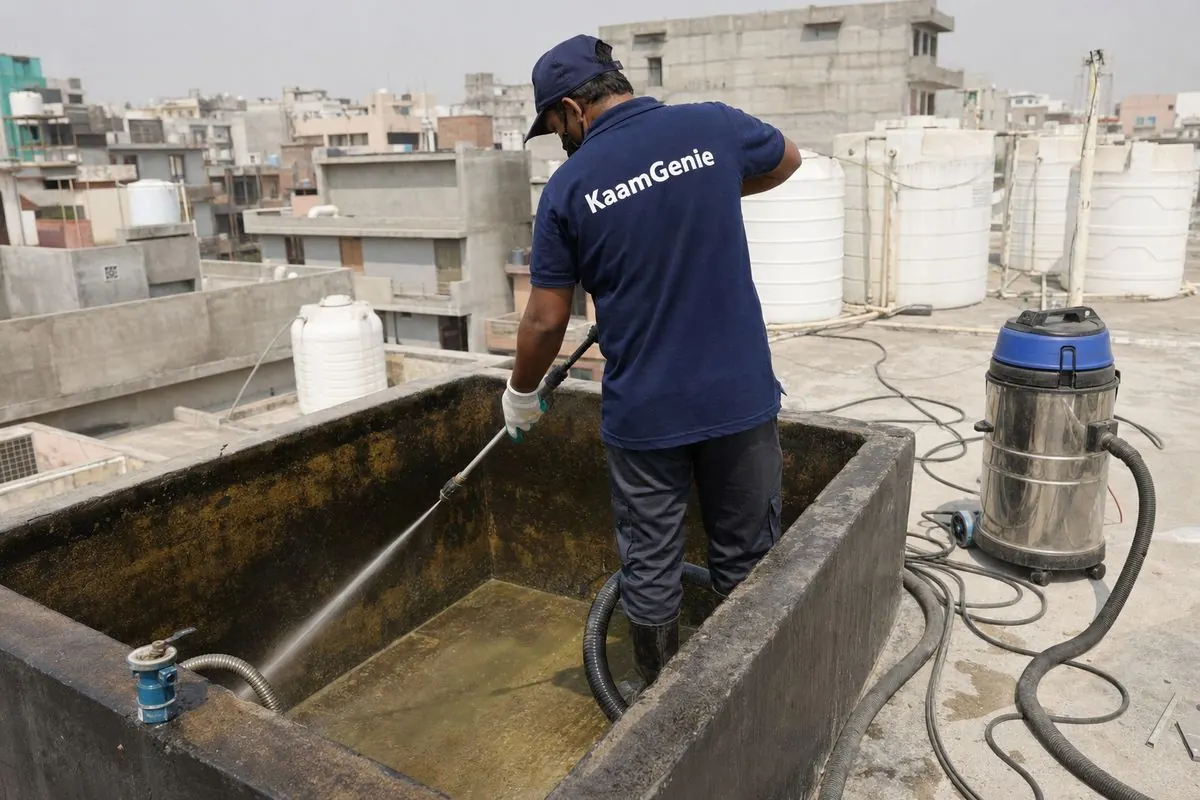 KaamGenie crew cleaning a overhead (rooftop) tank in Bijwasan, Delhi