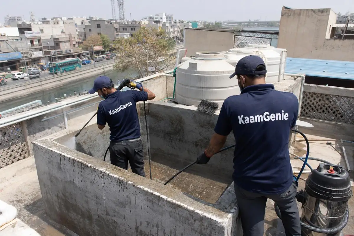 KaamGenie crew cleaning a overhead (rooftop) tank in Chand Bagh, Delhi
