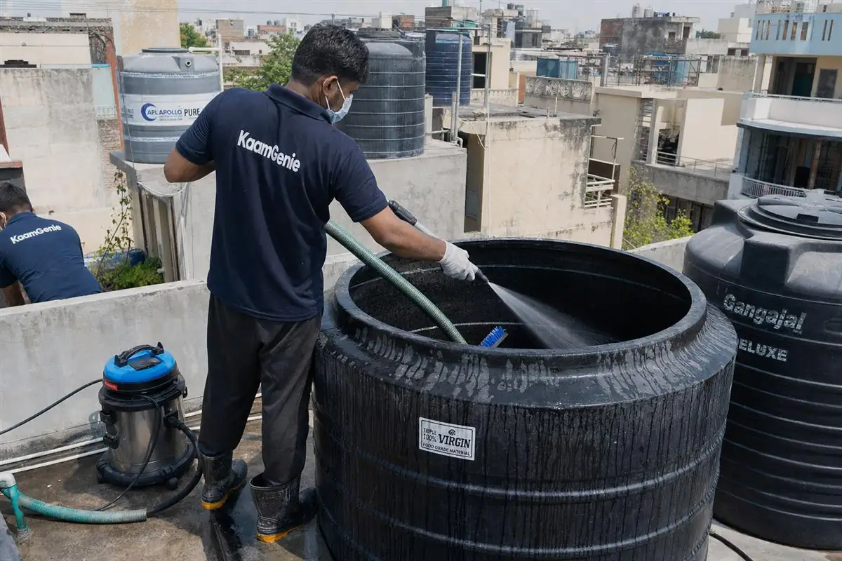 KaamGenie crew cleaning a overhead (rooftop) tank in Chirag Delhi, Delhi