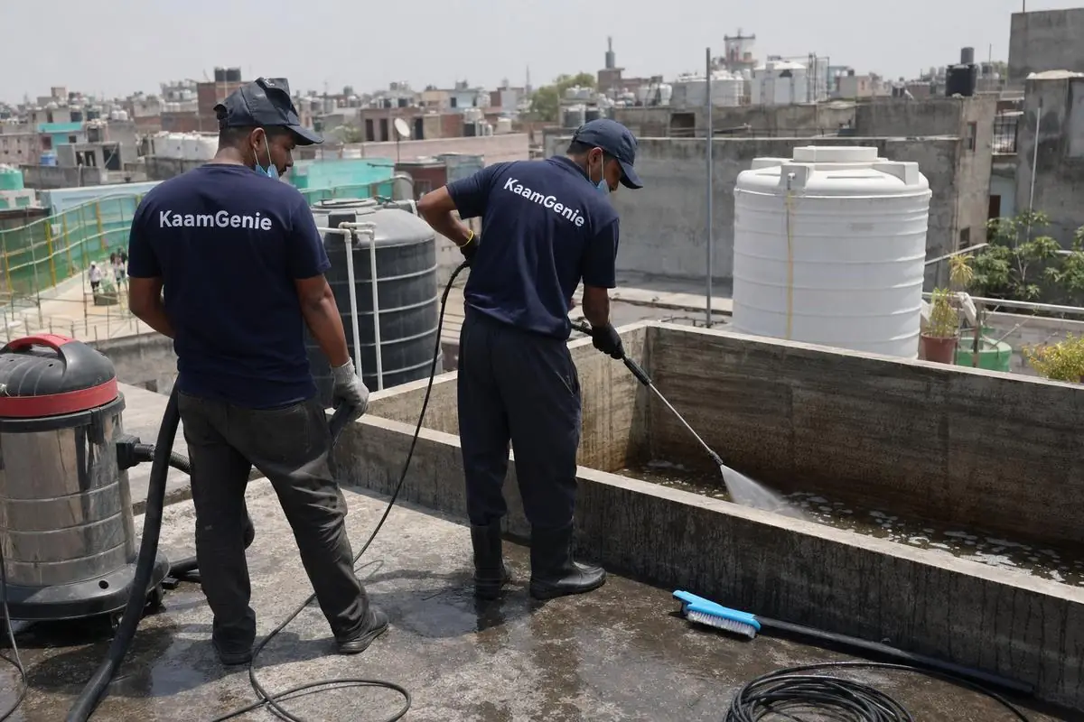 KaamGenie crew cleaning a overhead (rooftop) tank in Dakshinpuri, Delhi