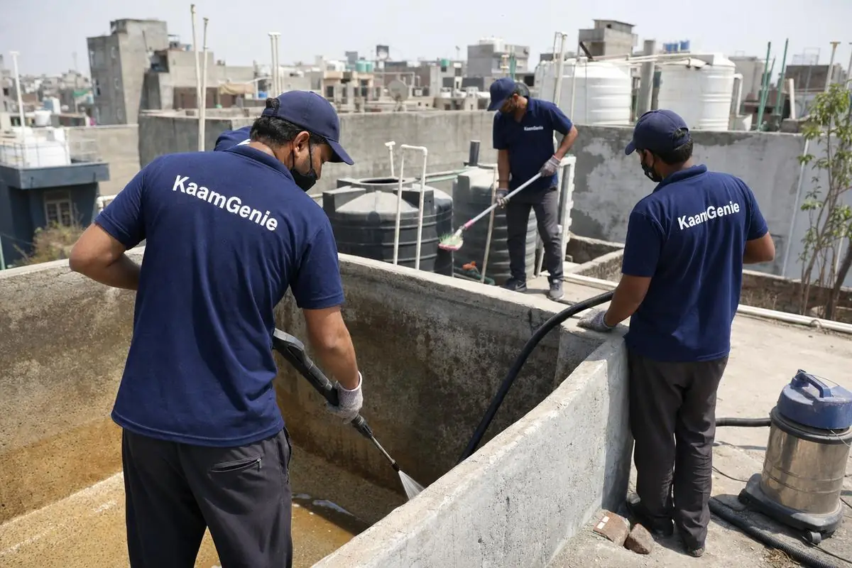 KaamGenie crew cleaning a overhead (rooftop) tank in Dwarka Mor, Delhi