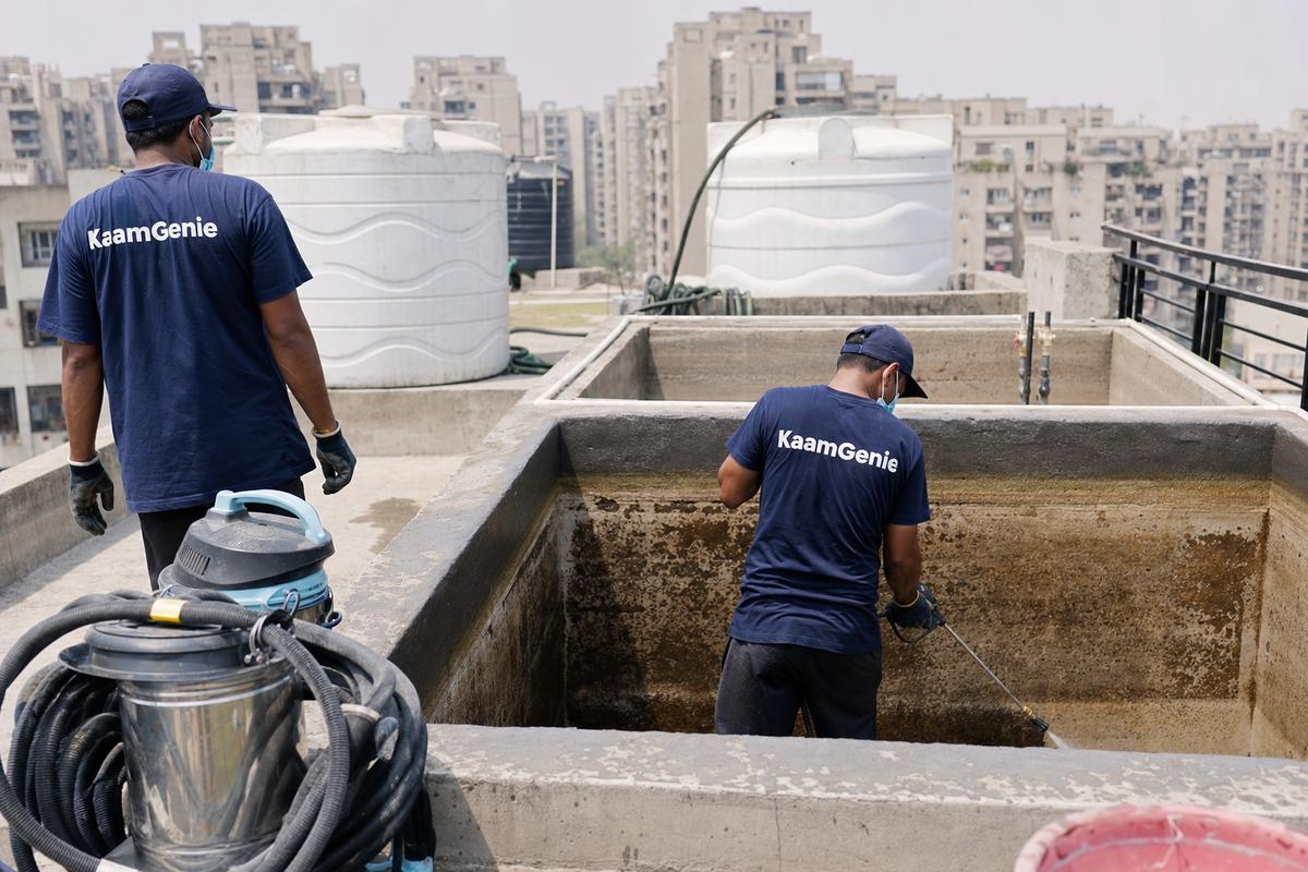 KaamGenie crew cleaning a overhead (rooftop) tank in Dwarka Sector 13, Delhi