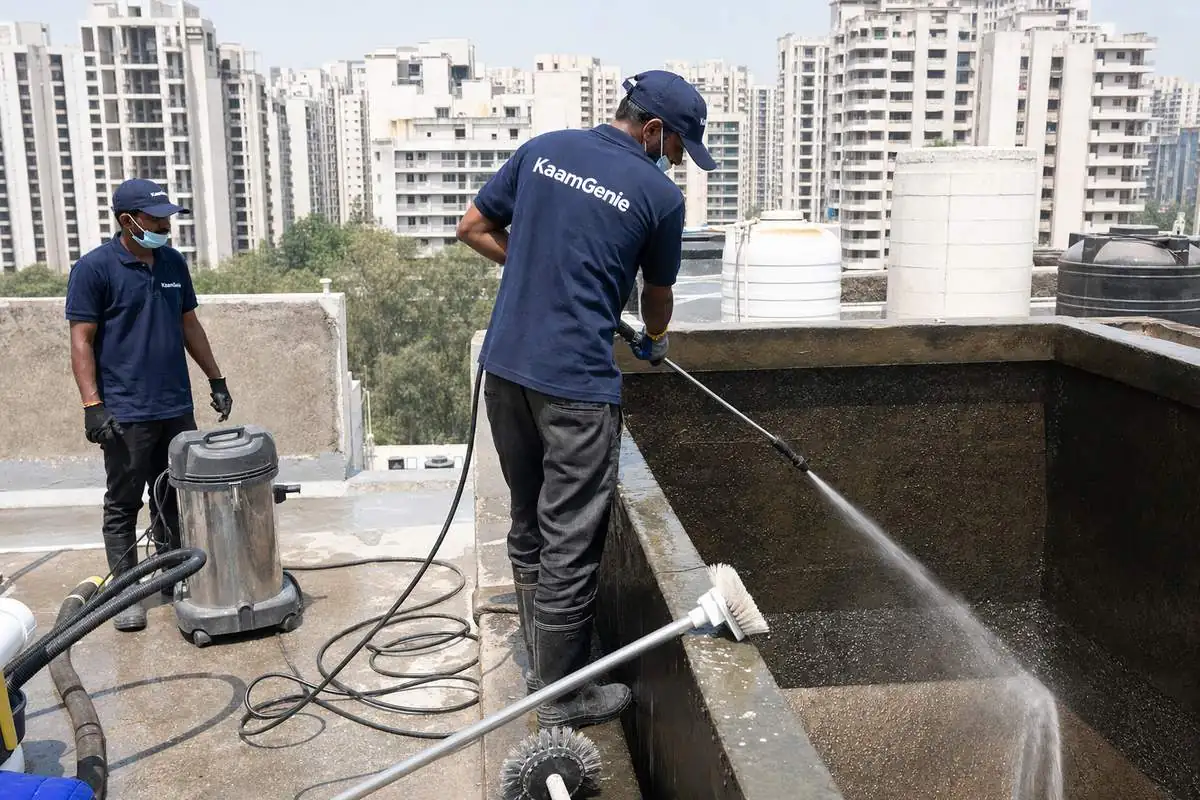 KaamGenie crew cleaning a overhead (rooftop) tank in Dwarka Sector 14, Delhi