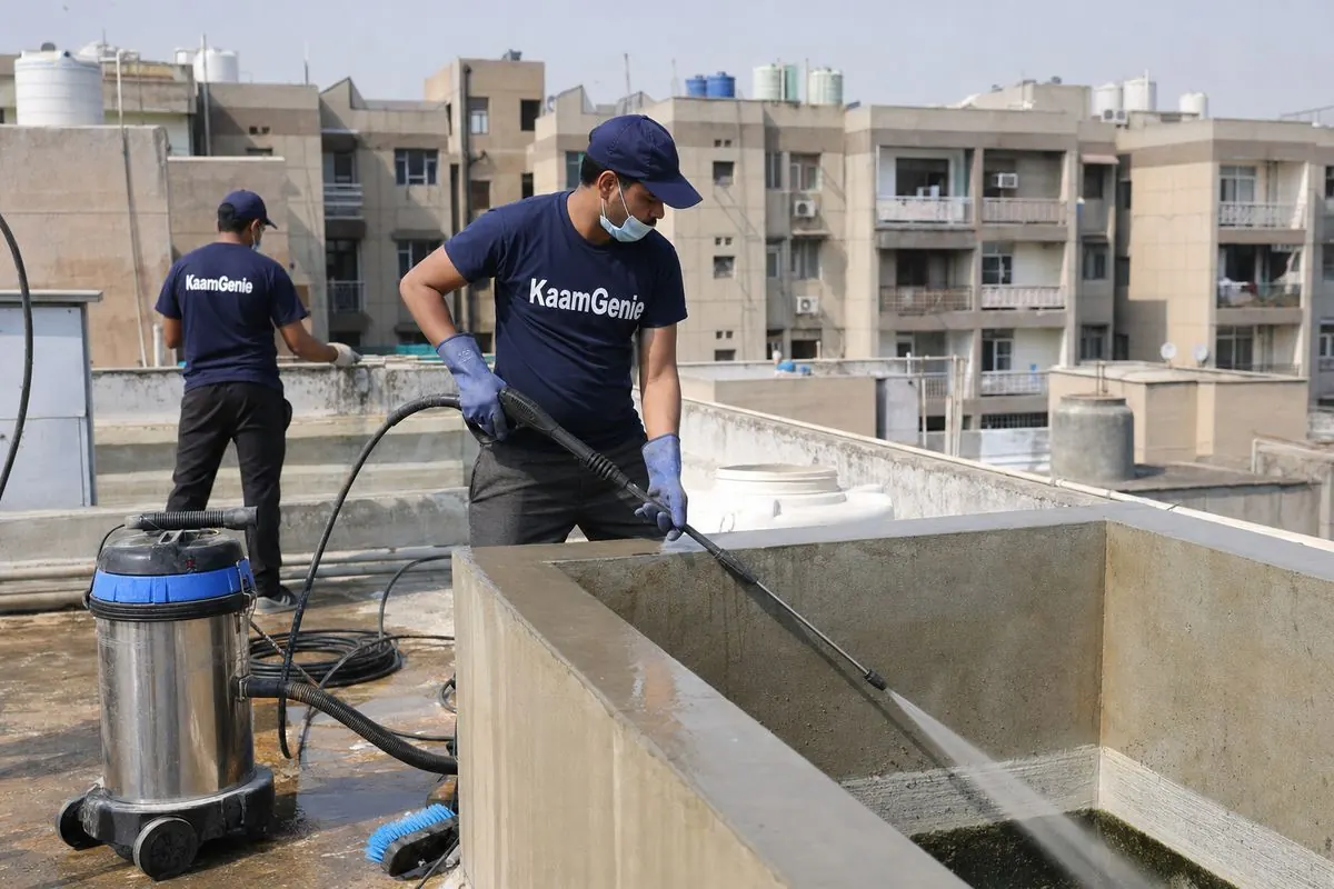 KaamGenie crew cleaning a overhead (rooftop) tank in Dwarka Sector 15, Delhi