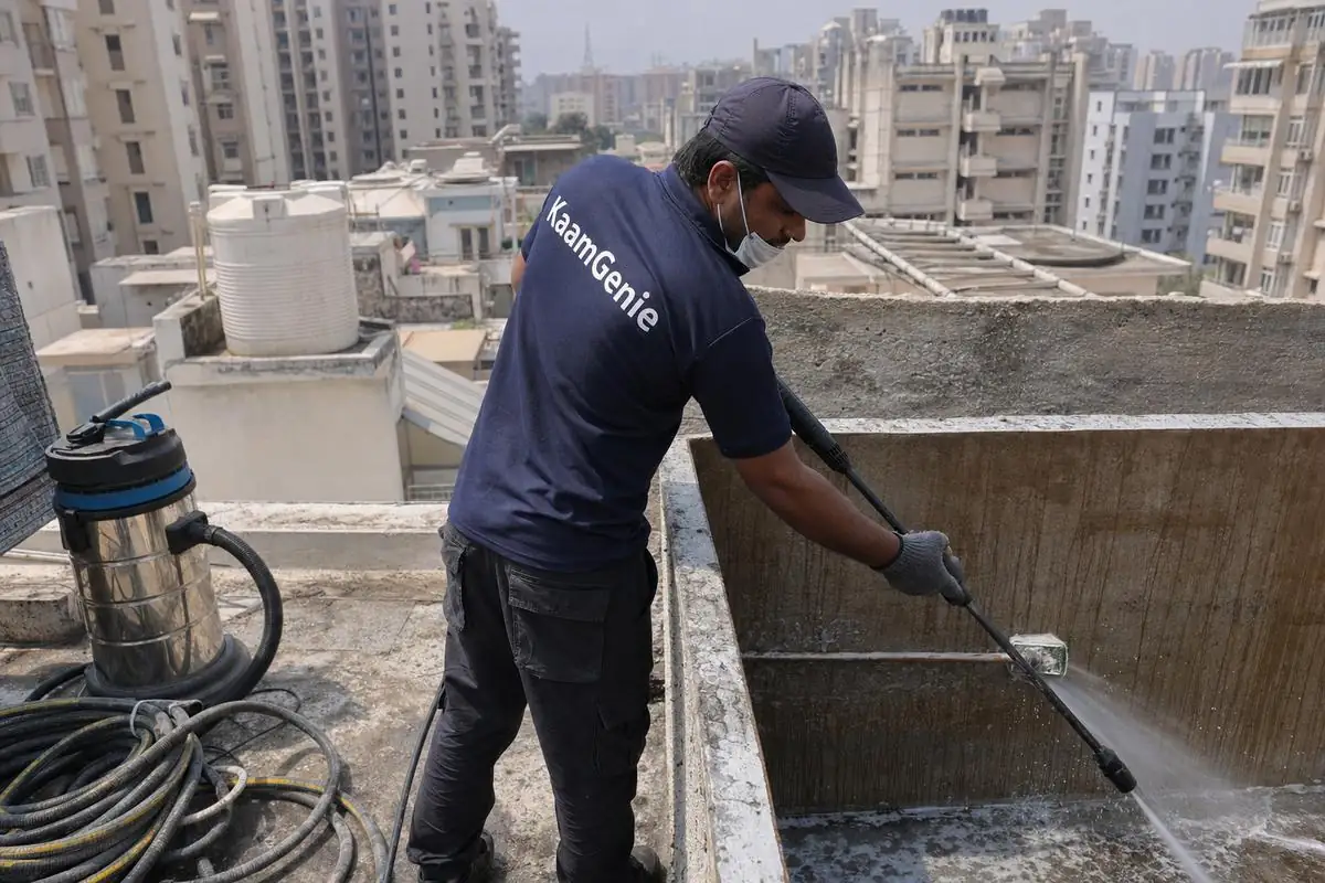 KaamGenie crew cleaning a overhead (rooftop) tank in Dwarka Sector 2, Delhi