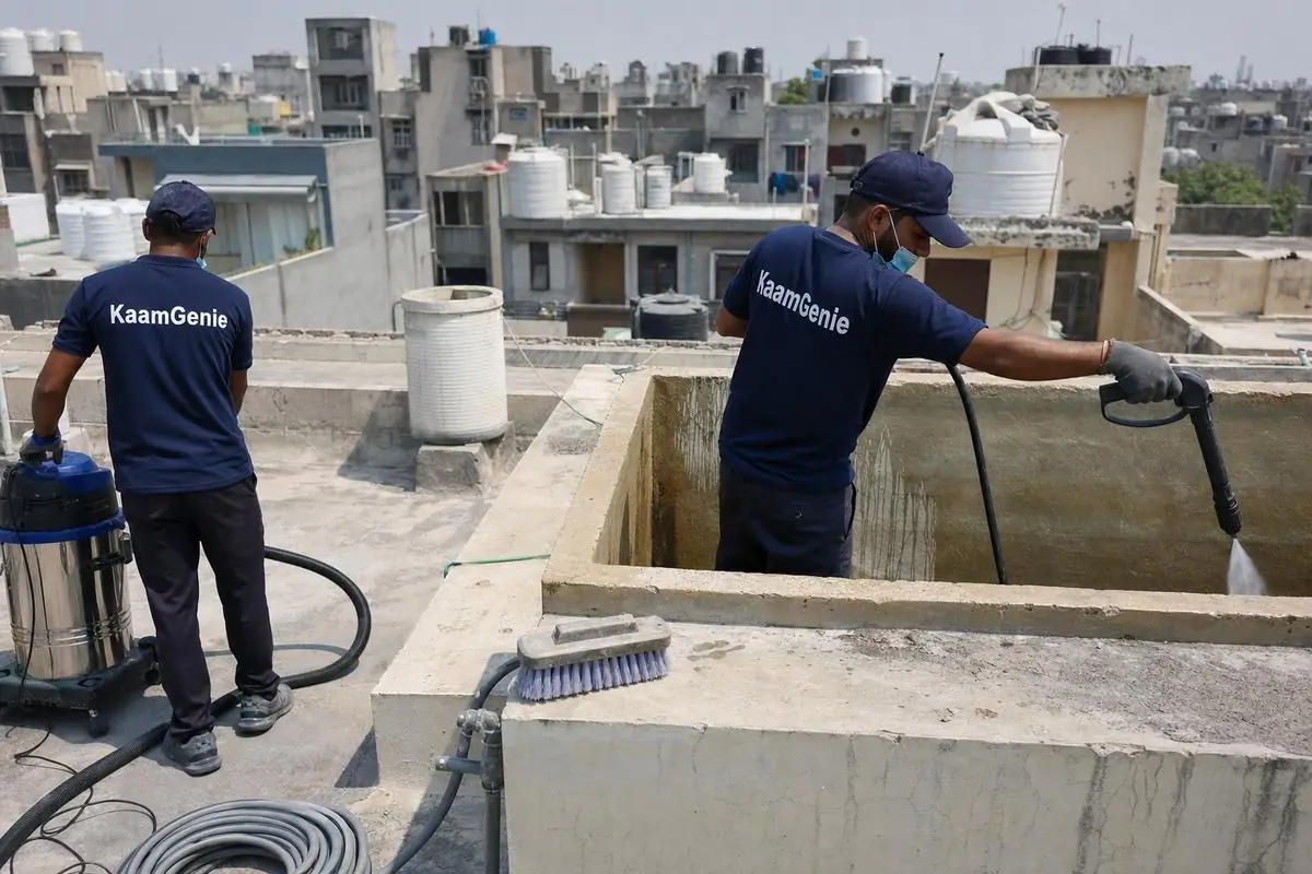 KaamGenie crew cleaning a overhead (rooftop) tank in Dwarka Sector 22, Delhi
