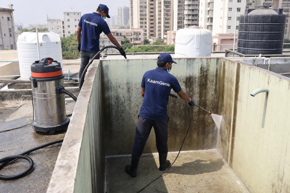 KaamGenie crew cleaning a overhead (rooftop) tank in Dwarka Sector 24, Delhi