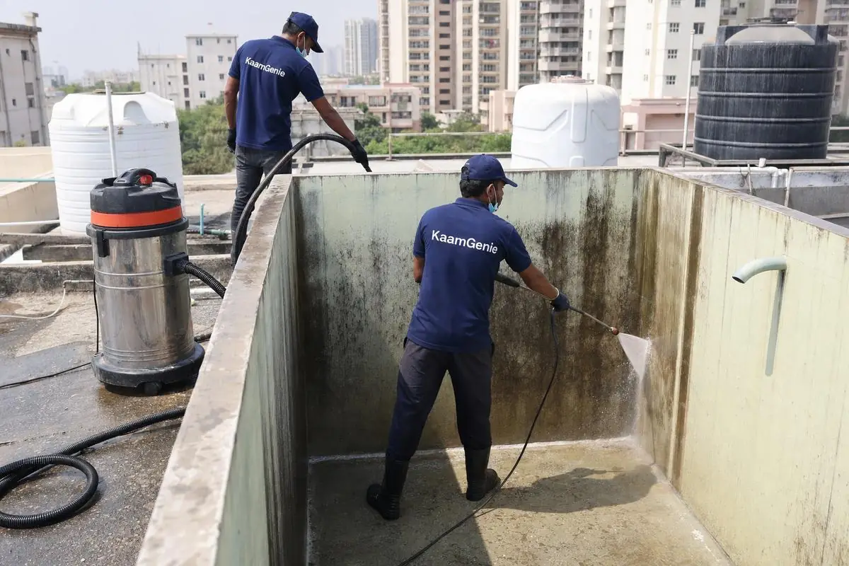 KaamGenie crew cleaning a overhead (rooftop) tank in Dwarka Sector 24, Delhi