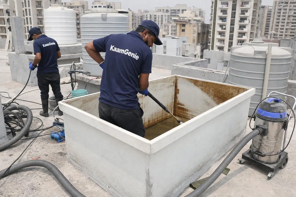 KaamGenie crew cleaning a overhead (rooftop) tank in Dwarka Sector 4, Delhi