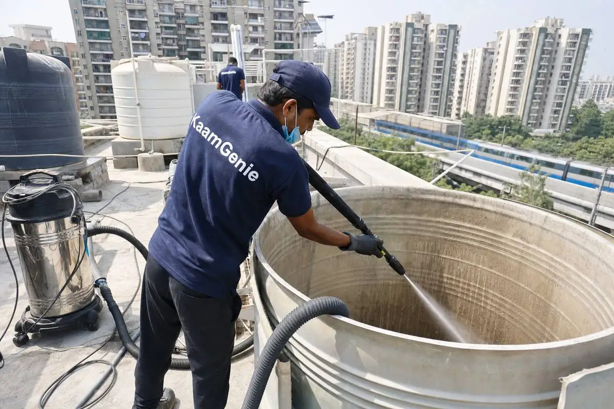 KaamGenie crew cleaning a overhead (rooftop) tank in Dwarka Sector 9, Delhi